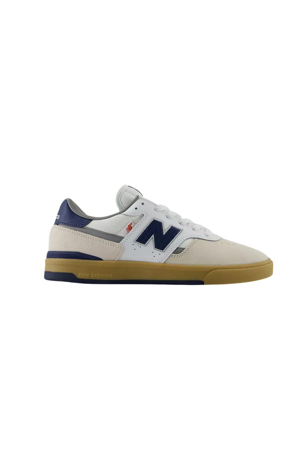 A New Balance low-top sneaker in off-white leather with navy blue overlays, a navy heel tab, a small red logo accent, and a gum-colored sole, shown against a plain white background.