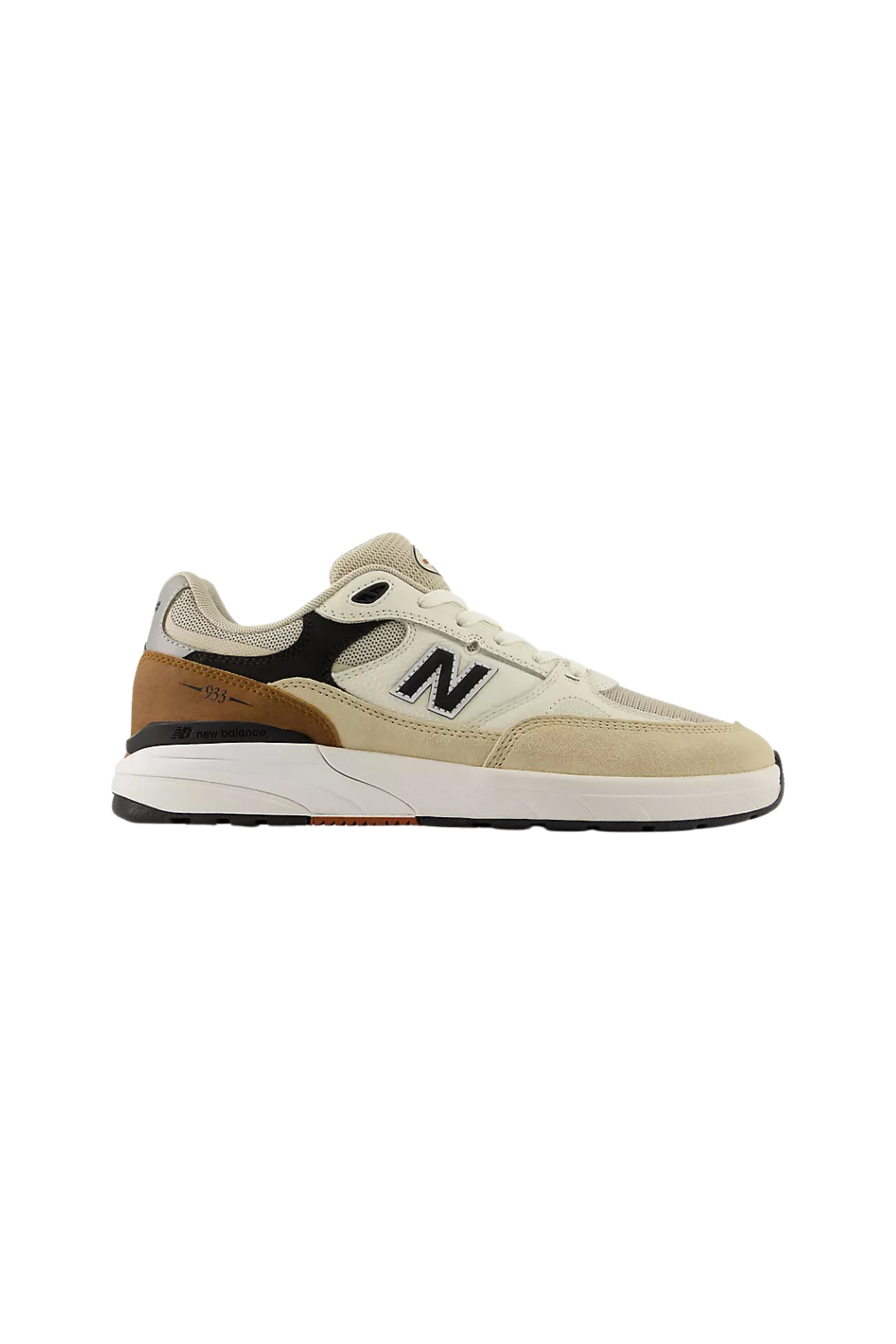 A New Balance sneaker in beige, brown, and black, shown from the side against a plain white background.
