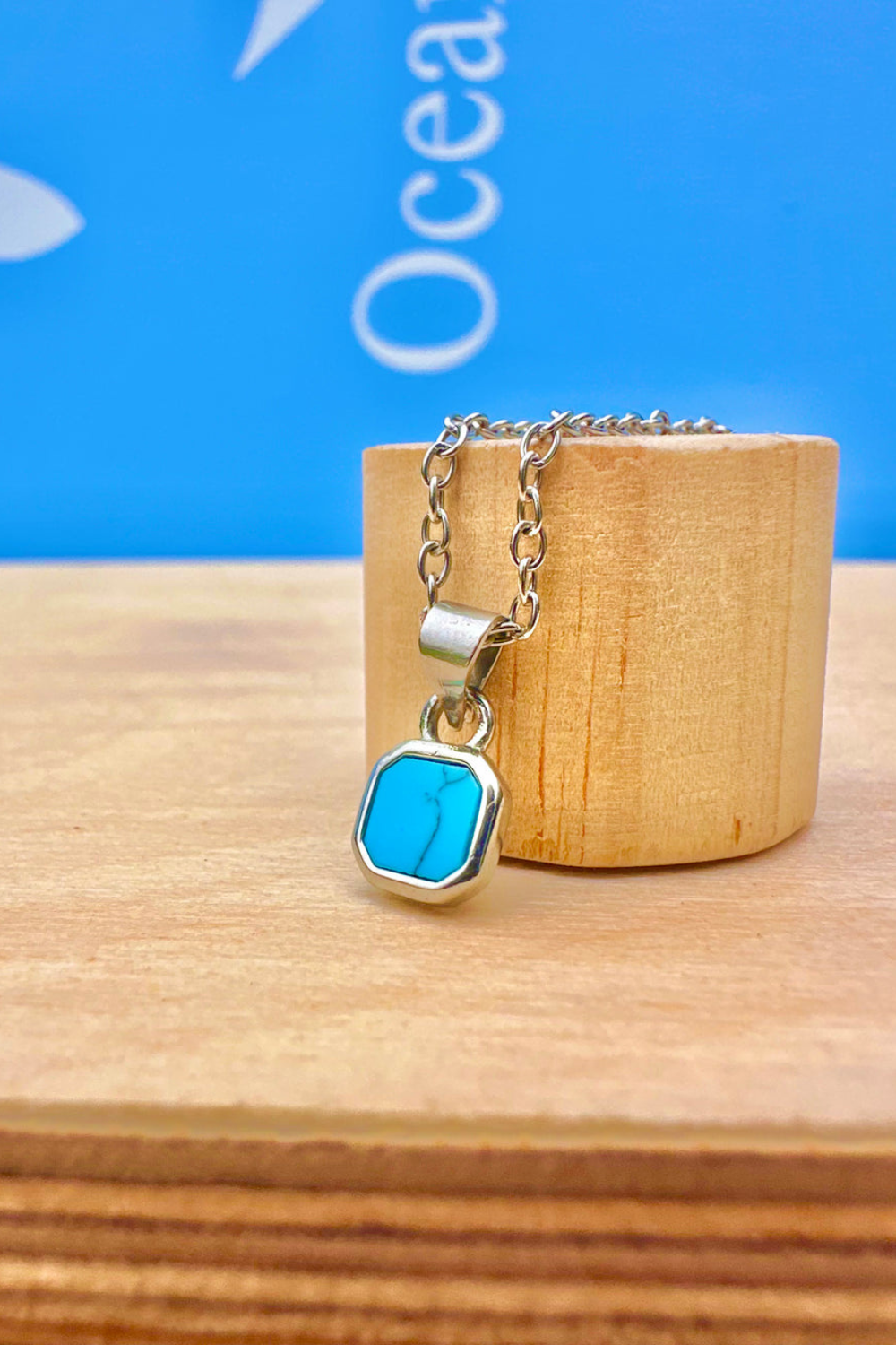 Silver necklace with a small turquoise stone pendant 