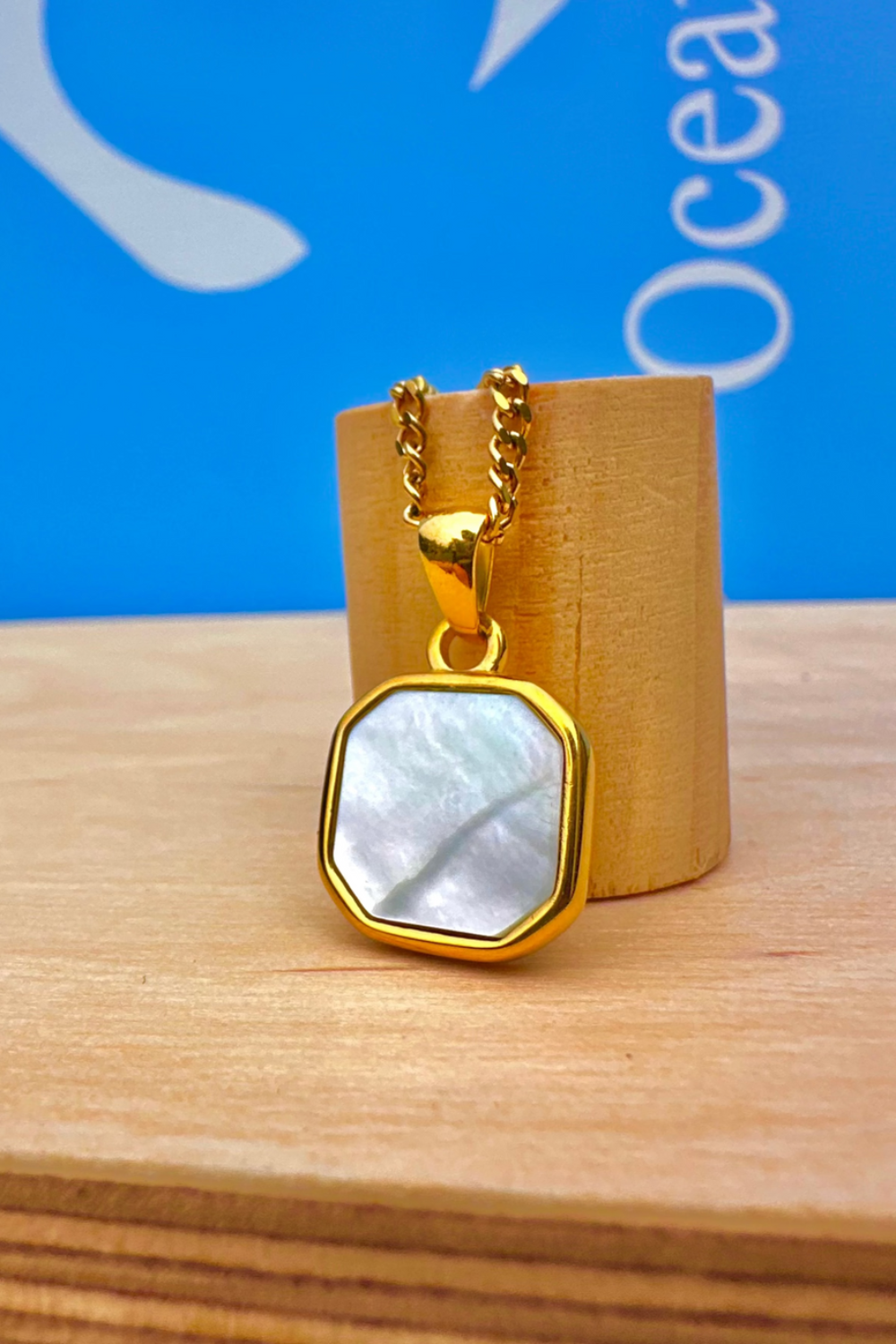 Gold necklace with a pearl shell stone pendant 