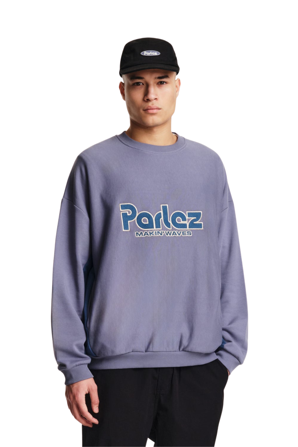 Person wearing a purple sweatshirt with a large blue Parlez logo on the chest