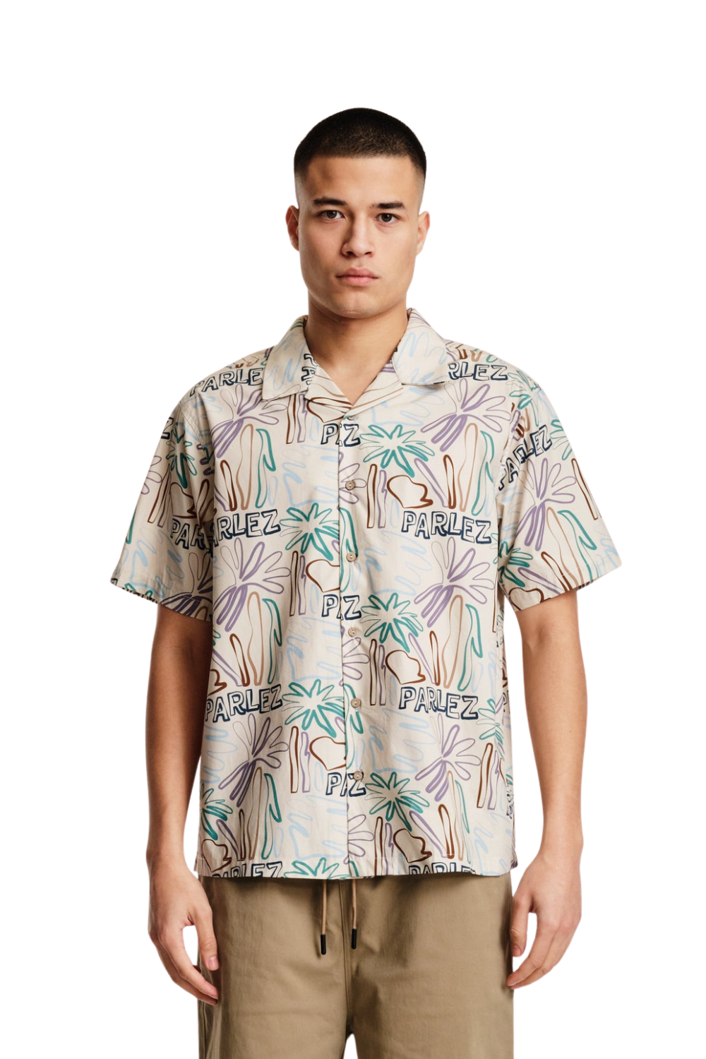 Man wearing a patterned shirt with visible branding on a white background