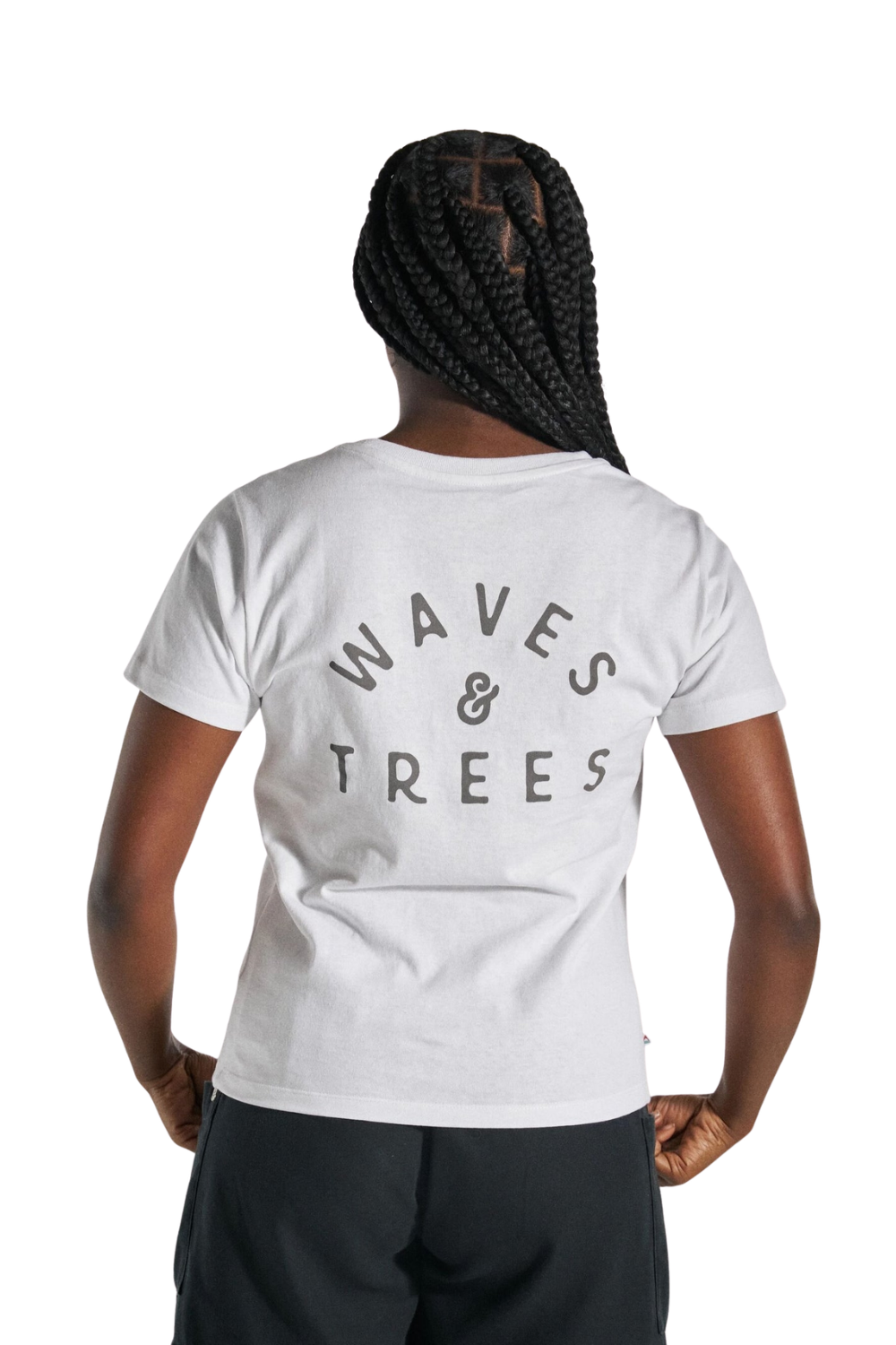 A person shown from the back wearing a white short-sleeve T-shirt with a dark gray graphic reading 'WAVES & TREES' across the upper back, paired with dark shorts against a plain white studio background.