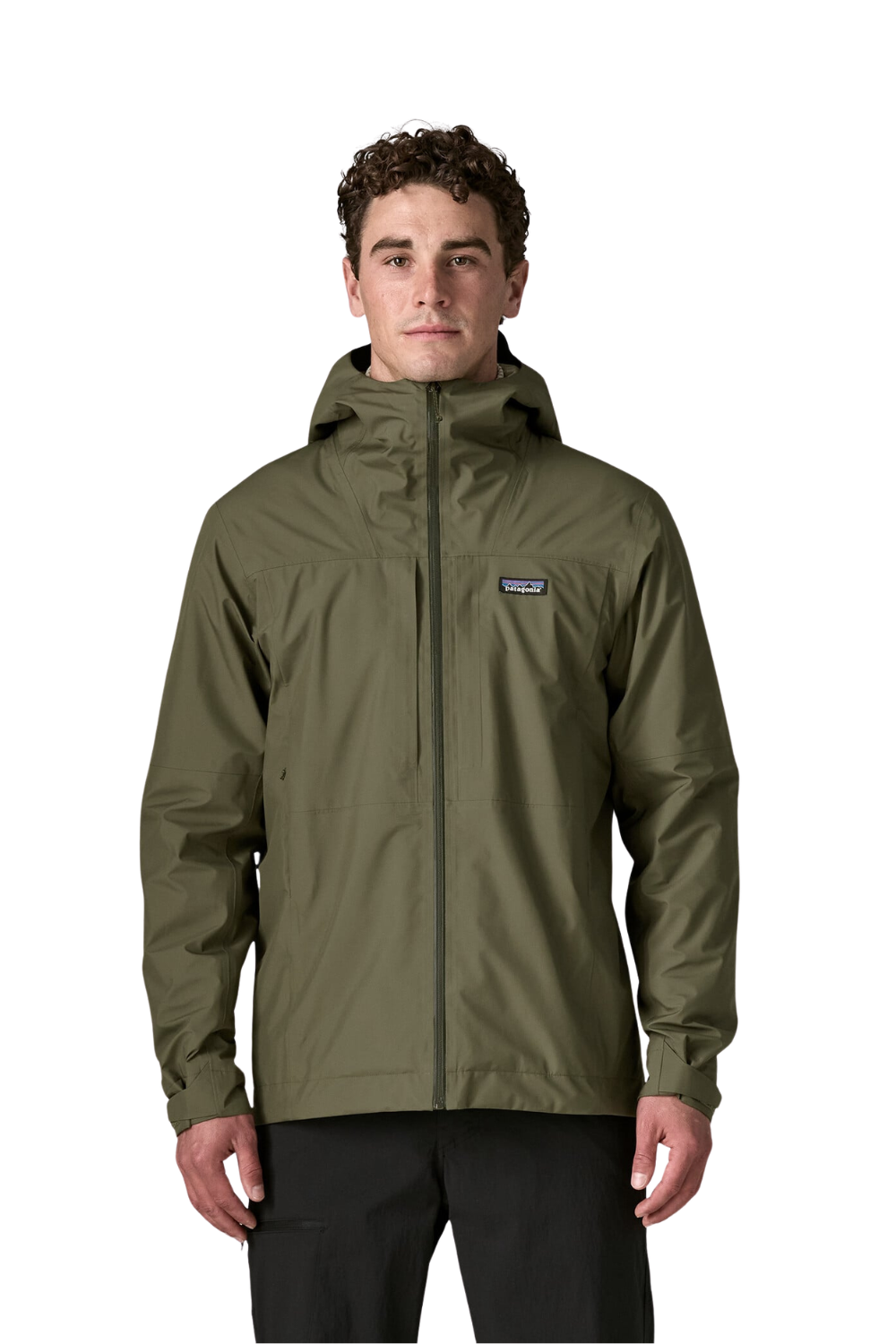 A man wearing a Patagonia insulated, hooded zip-up jacket in olive green, paired with black pants, photographed against a solid white background.