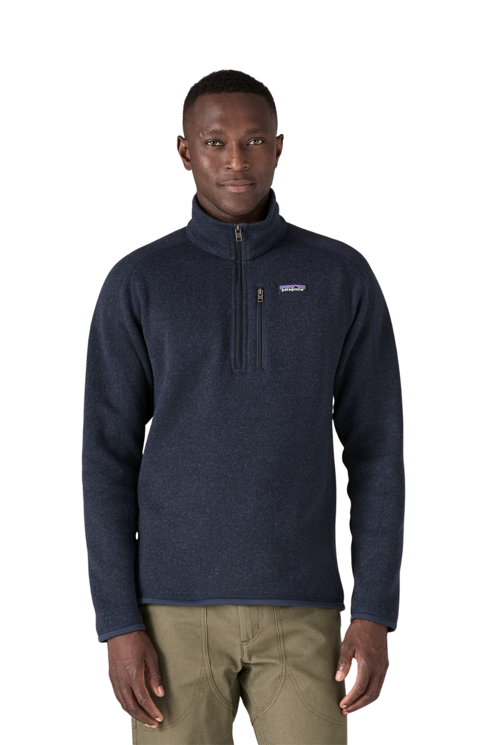 Man wearing a navy Patagonia fleece pullover on a white background