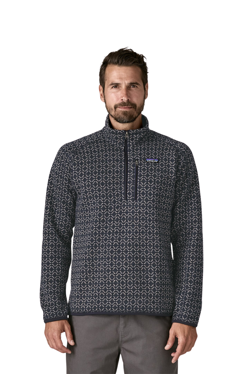 Man wearing a patterned pullover with a visible brand logo on a white background