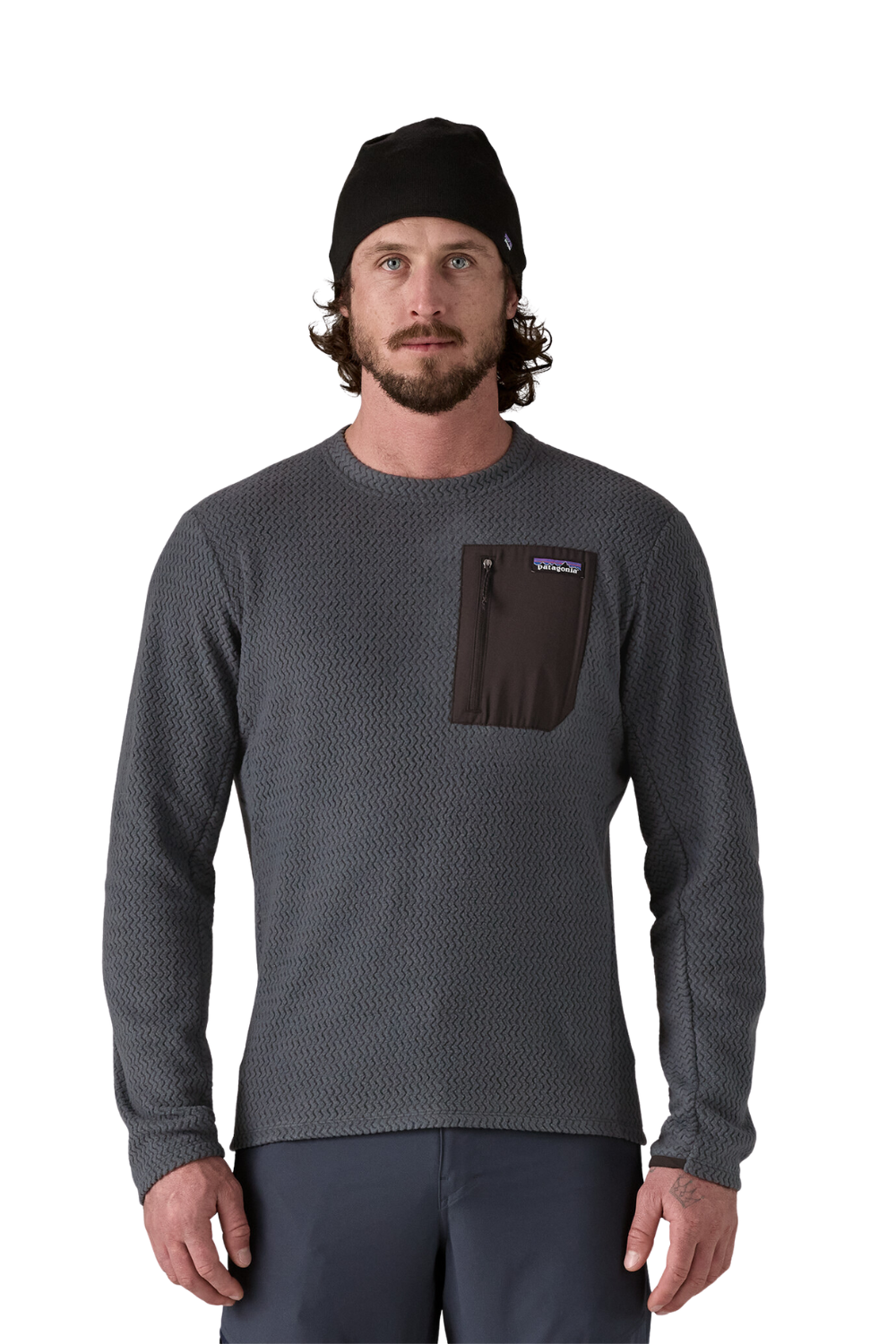 Man wearing a gray long-sleeve shirt with a pocket and black beanie on a white background