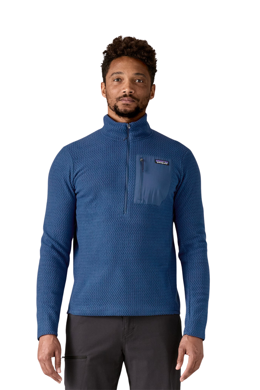 Man wearing a blue pullover with a brand logo on a white background