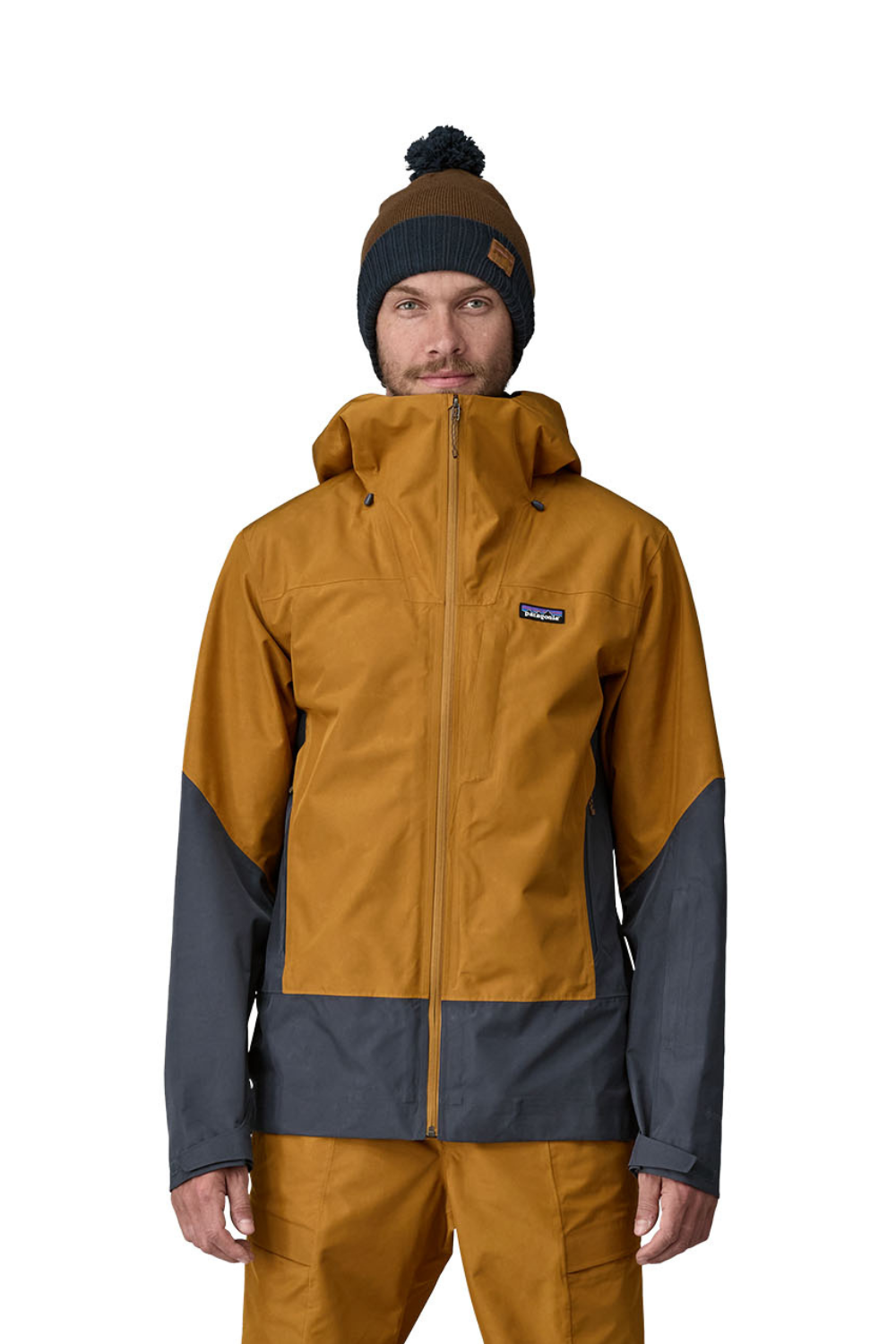 Person wearing a mustard yellow and gray jacket with Patagonia logo on a white background