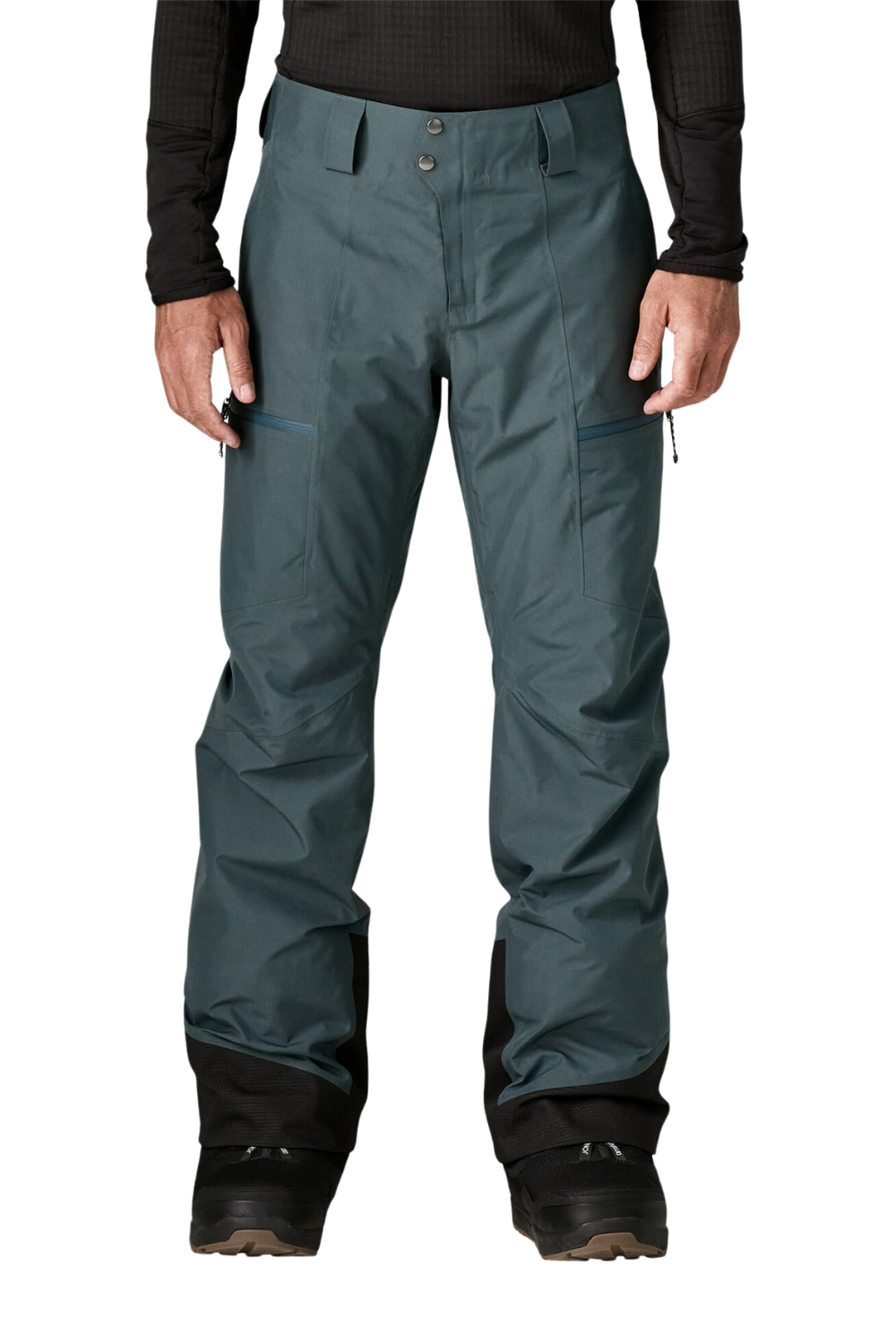 A person wearing dark slate green snow pants with black knee panels and black boots, shown from the waist down against a plain white background.