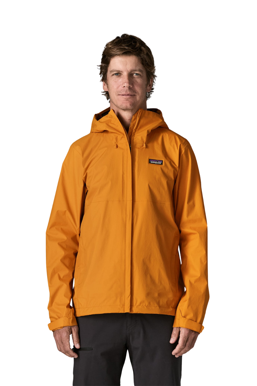 A man wearing a bright orange Patagonia hooded rain jacket and dark pants, standing against a plain white background.