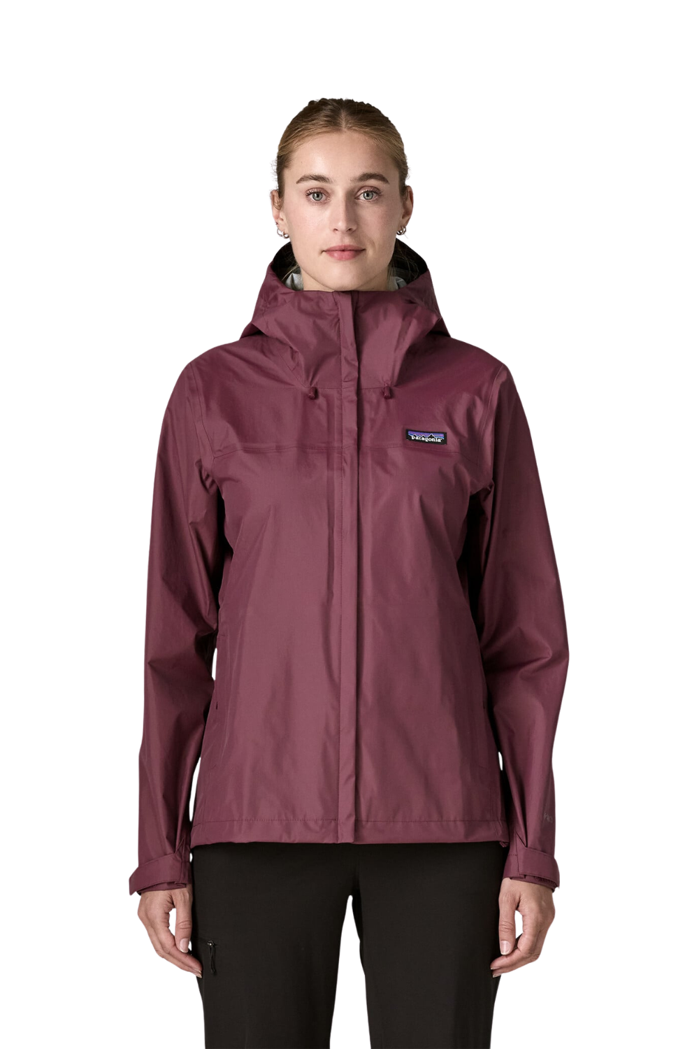 A woman in profile wearing a hooded Patagonia rain jacket in a deep plum or burgundy shade, paired with black pants, against a solid off-white background.
