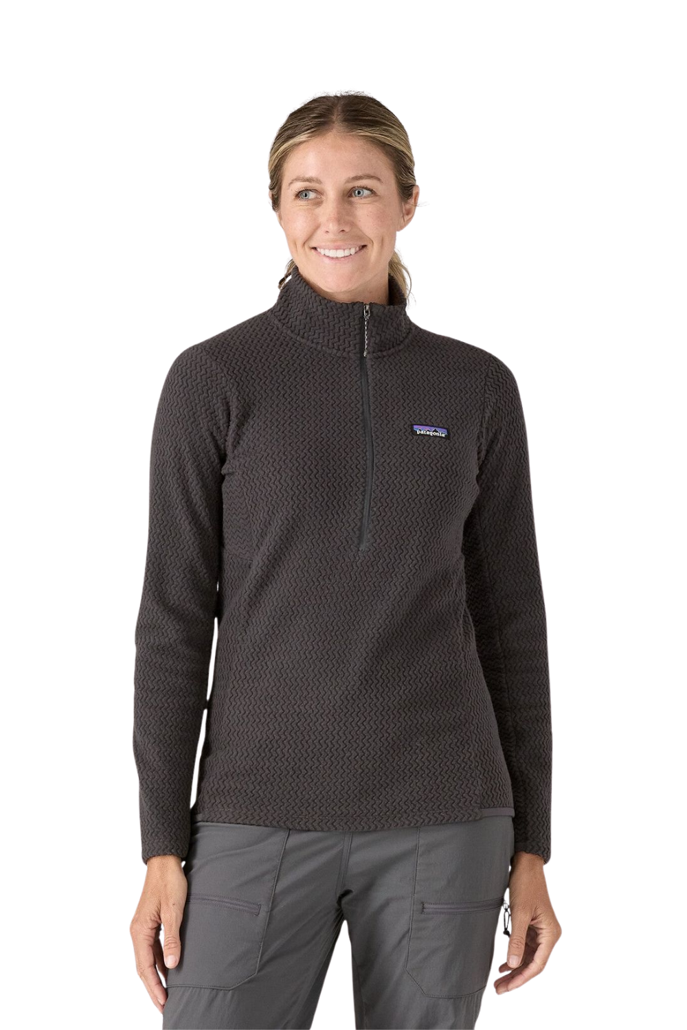 Woman wearing a black pullover with a visible brand logo on a white background