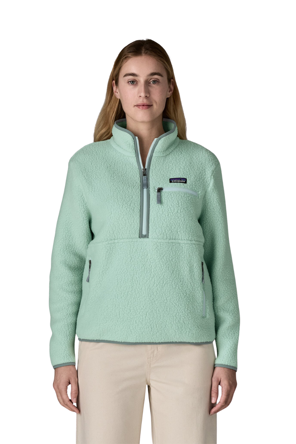 Woman wearing a light green fleece pullover with a brand logo on a white background