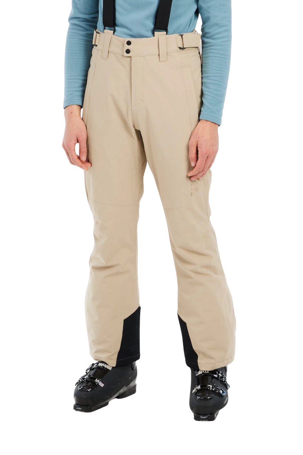 Person wearing beige ski pants with a blue top and black ski boots on a white background