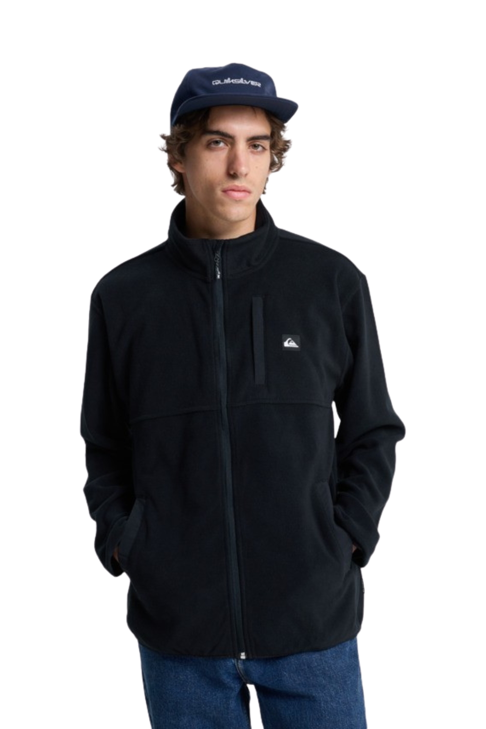 Person wearing a black fleece jacket and blue cap on a white background