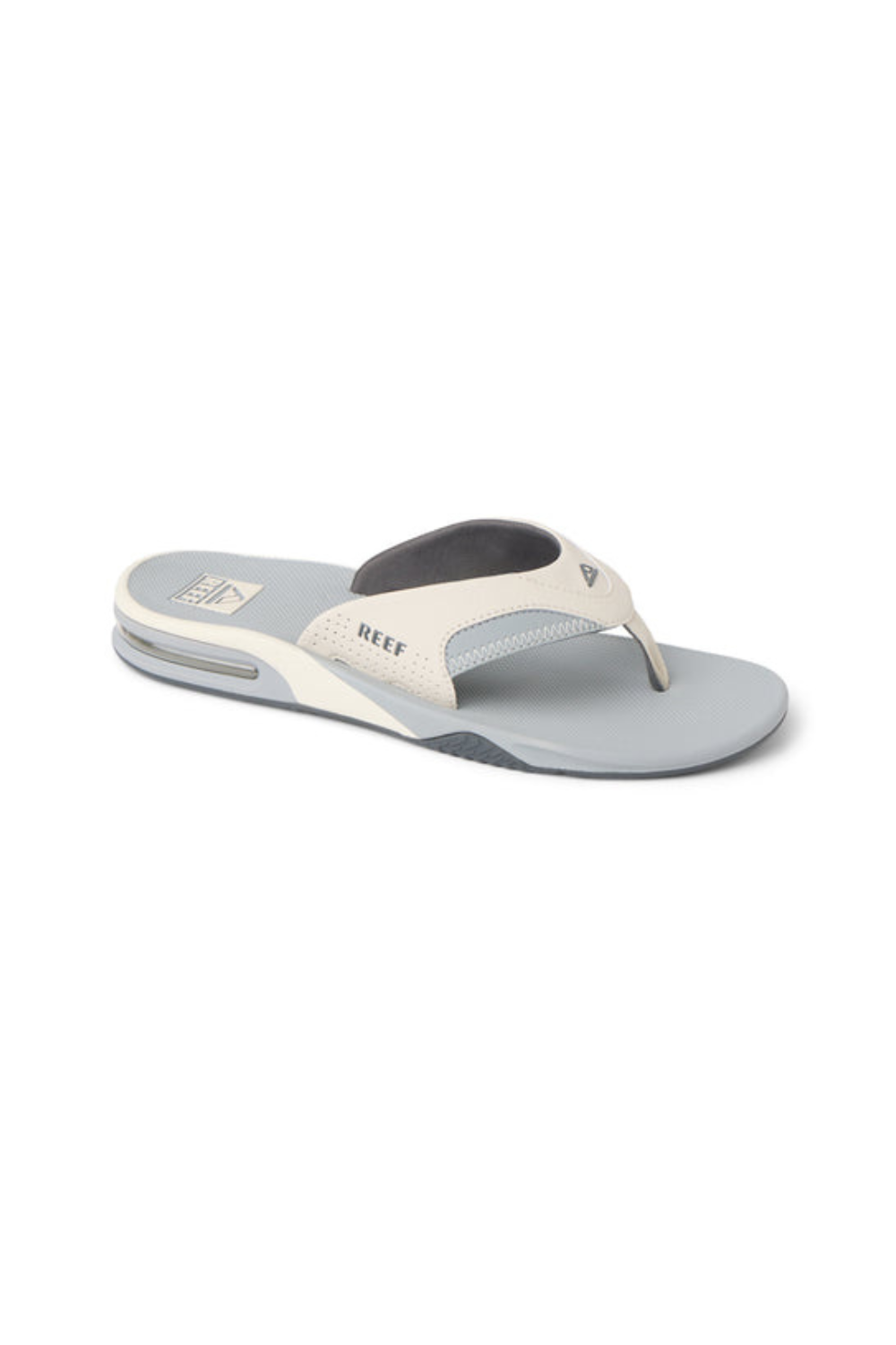 Gray and white sandal with 'REEF' branding on a white background