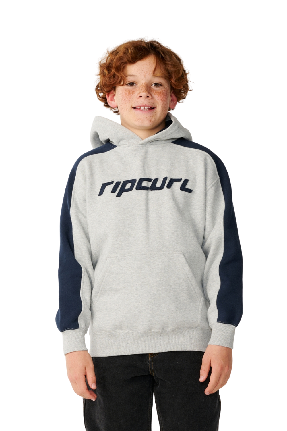 A young boy with curly red hair wearing a heather gray and navy blue colorblock hoodie with the Rip Curl logo across the chest, set against a plain white background.