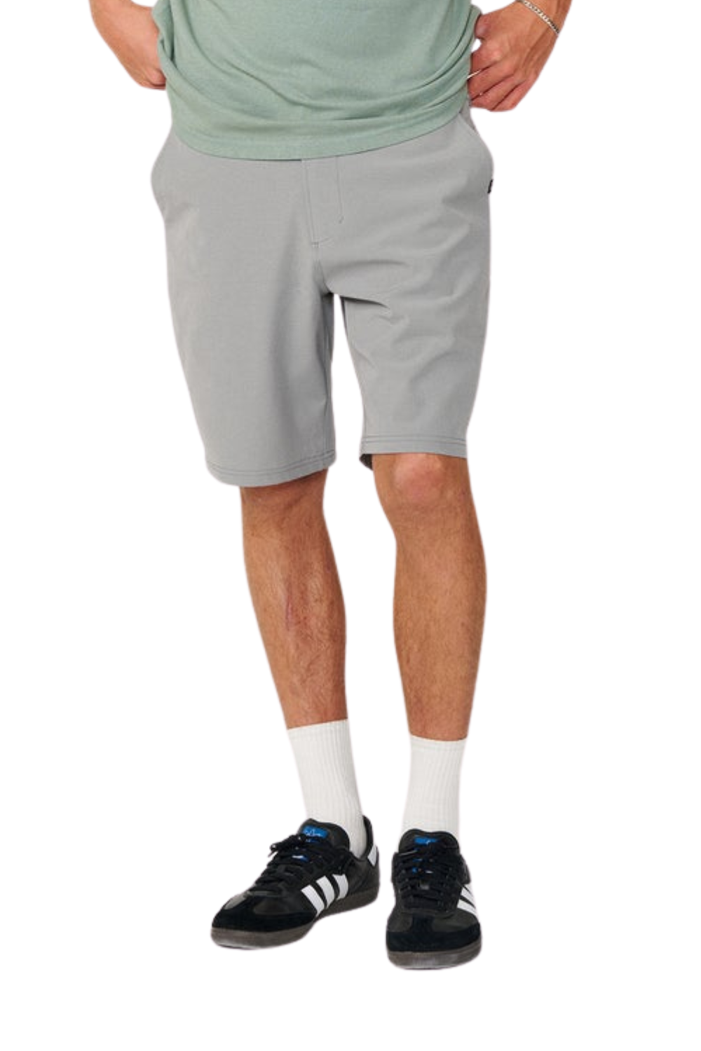Person wearing grey shorts on a white background