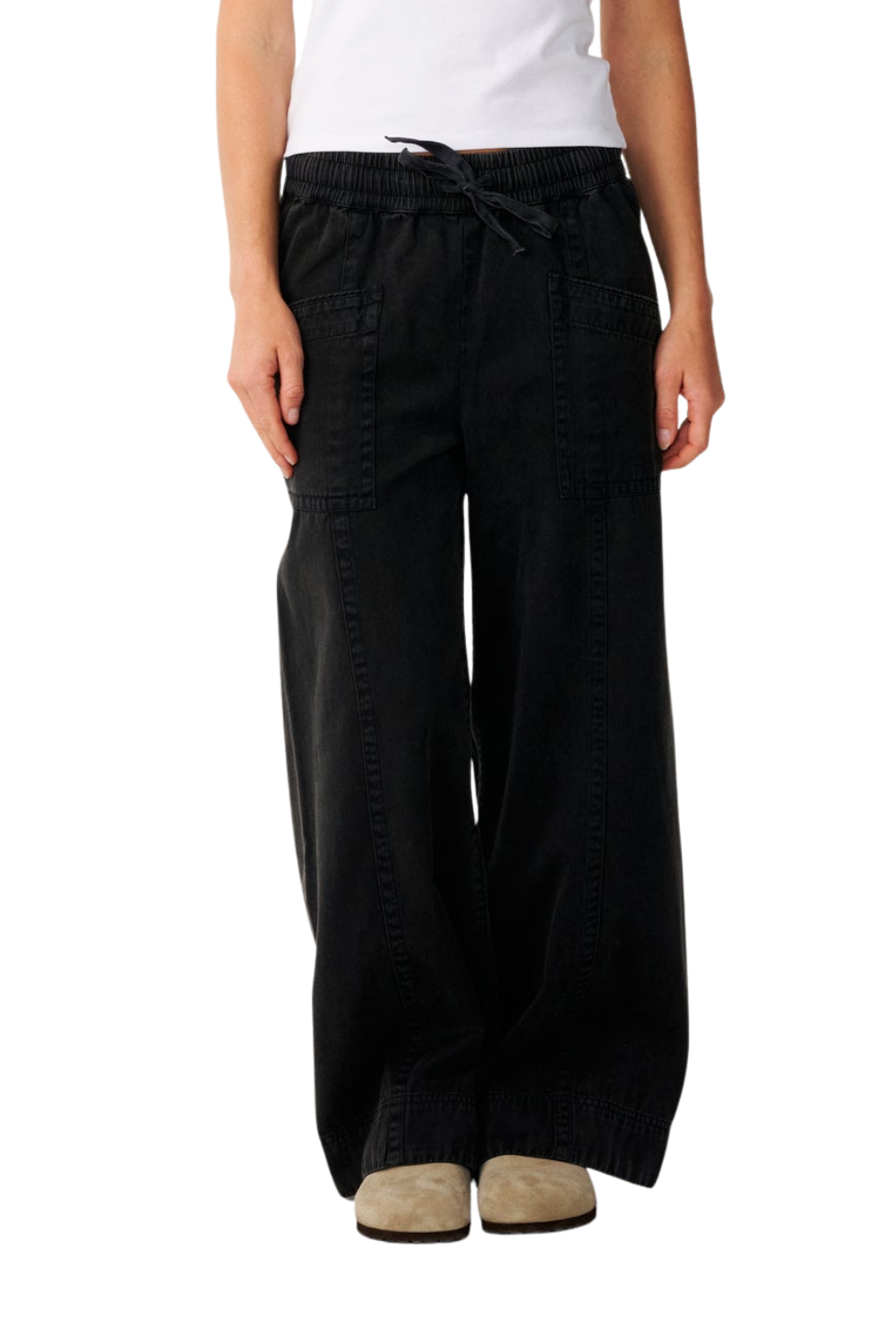 Black wide-leg pants with an elastic drawstring waist, shown on a model from the waist down wearing a white top and beige shoes against a white background.