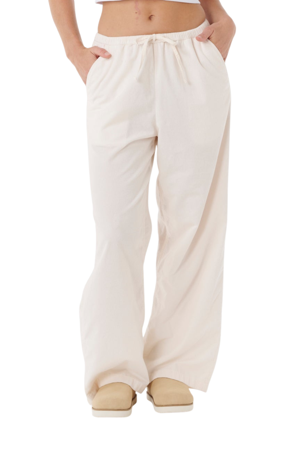 Person wearing off white cord trousers