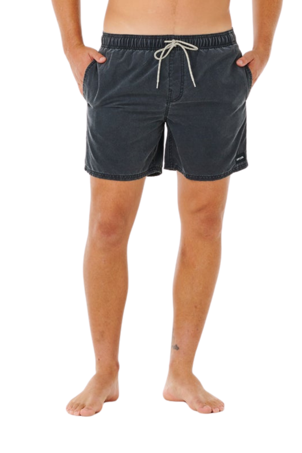 Person wearing washed black shorts on a white background