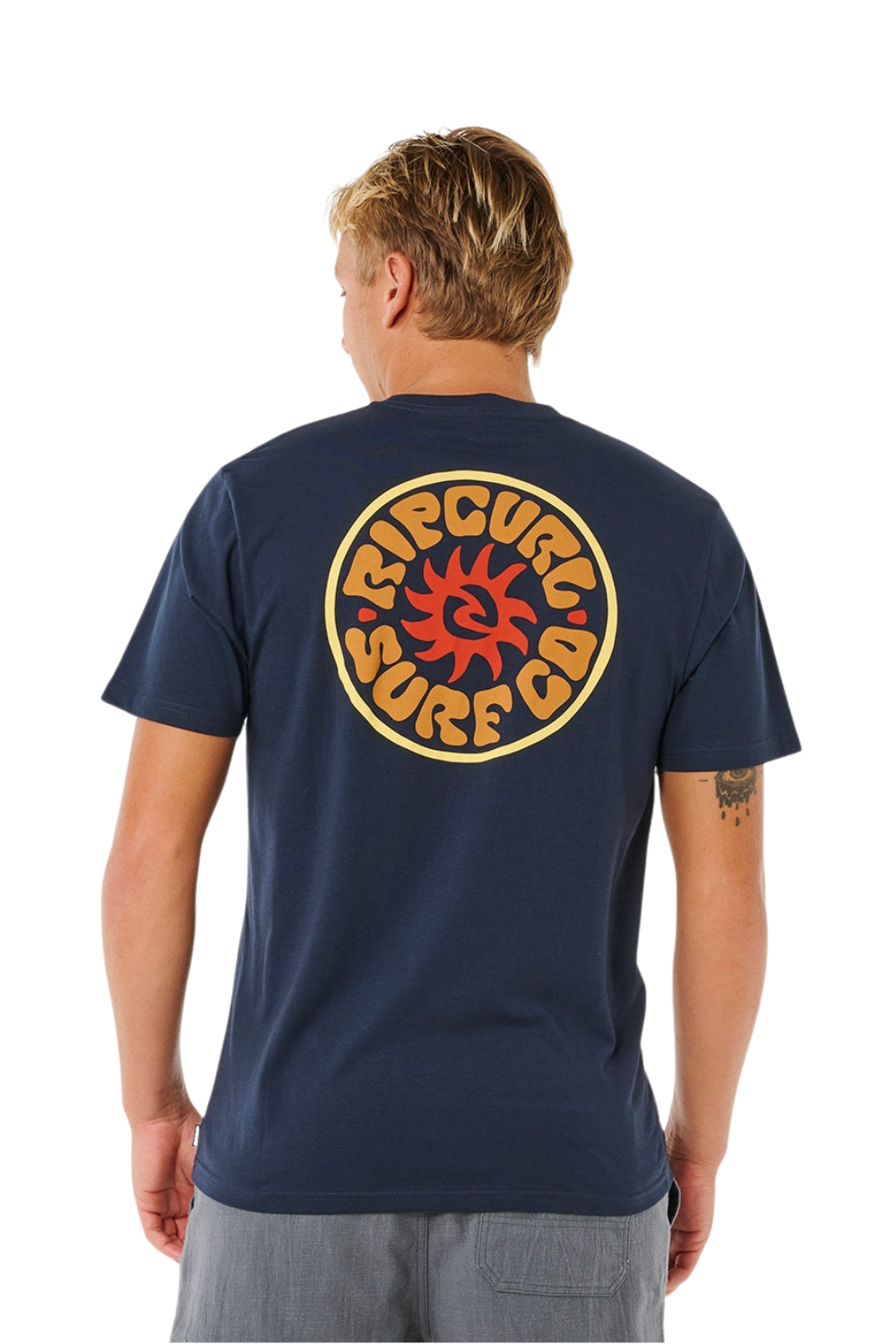 Person wearing a navy t-shirt with bold Rip curl logo on the back 