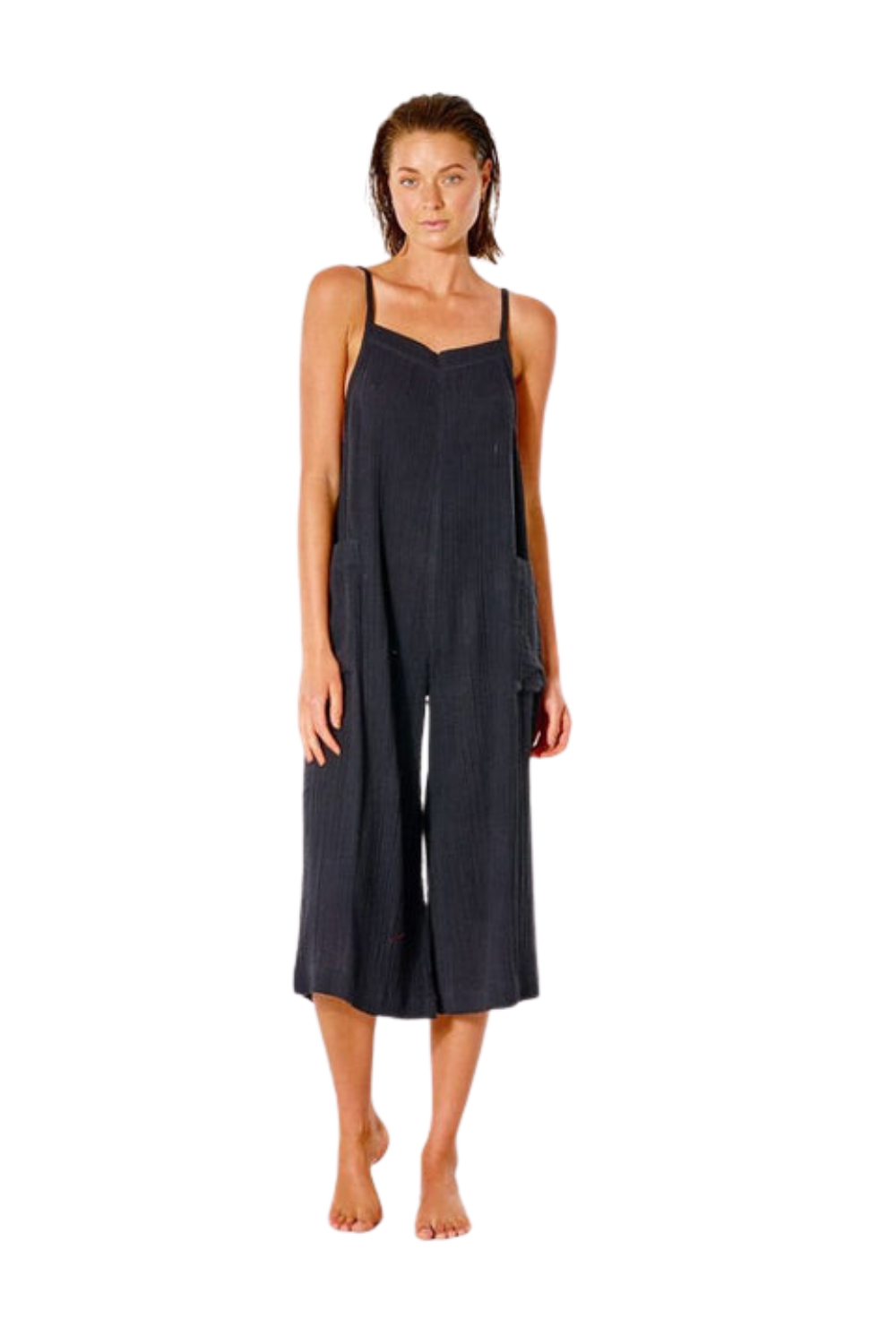 Woman wearing a black jumpsuit on a white background