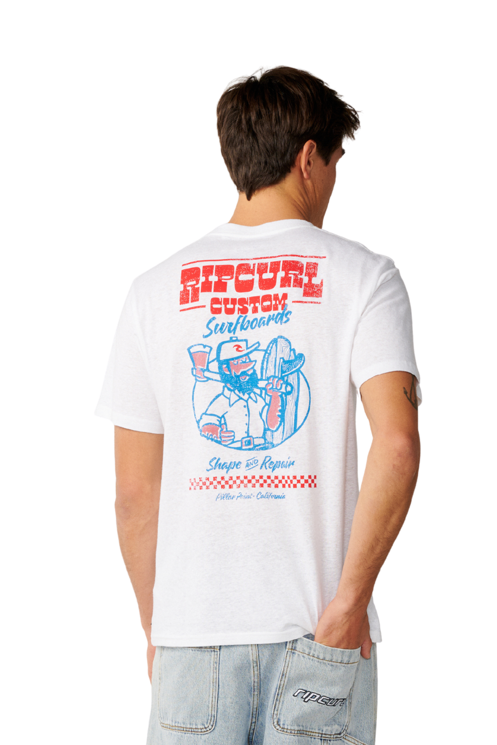 A man viewed from behind wearing a white short-sleeve t-shirt with a large red and blue graphic print on the back, paired with light-wash jeans.