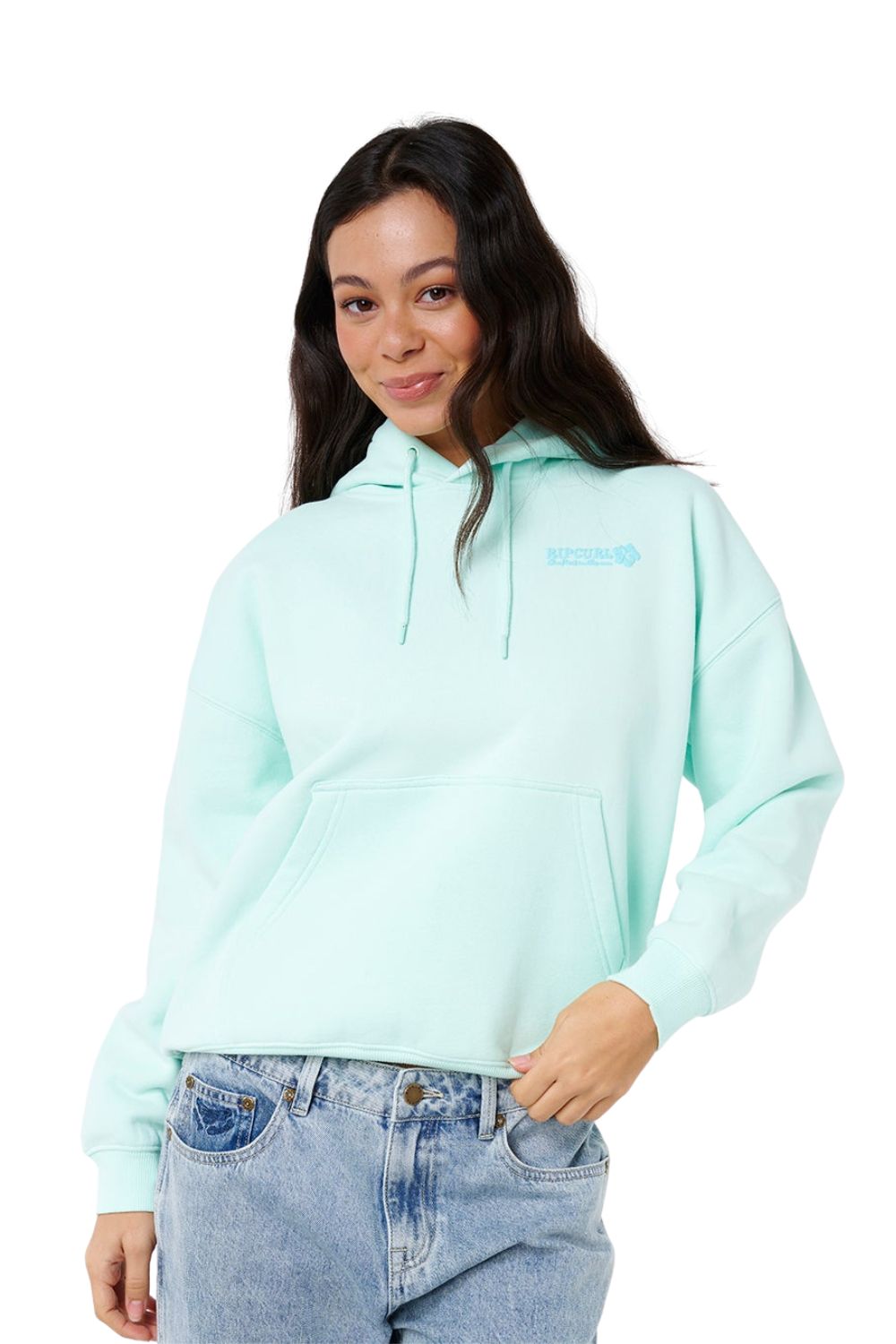 Woman wearing a light blue hoodie with a Rip Curl brand logo on a white background