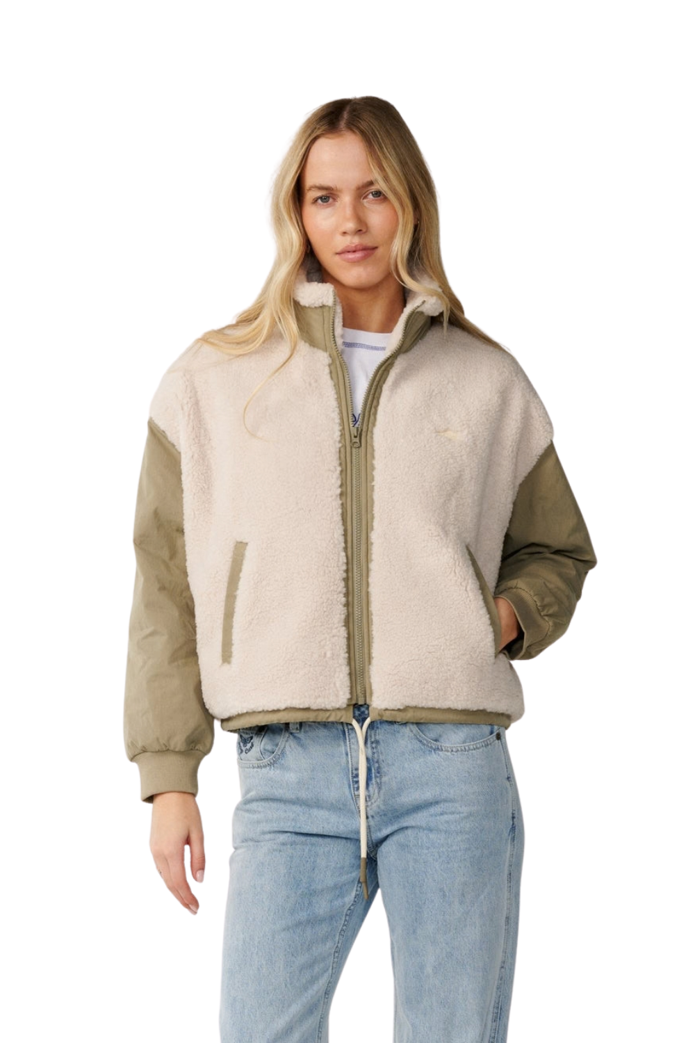 A woman modeling a color-blocked Rip Curl sherpa jacket with a cream sherpa body, olive green sleeves, and a matching olive green zipper, paired with light blue jeans against a white background.