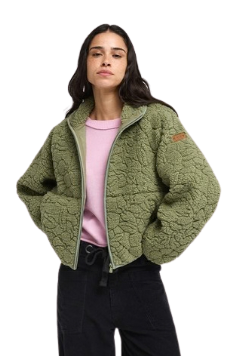 A woman wearing a cropped, textured Roxy fleece jacket in sage green, styled over a light pink top and black pants, against a plain white background.