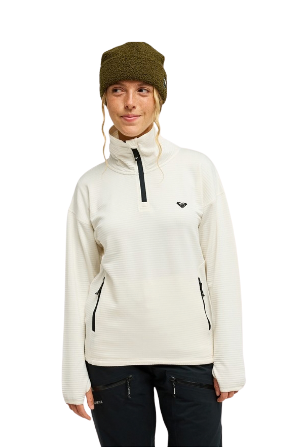 A woman wearing a cream-colored Roxy quarter-zip fleece pullover with black zipper accents, a dark olive green knit beanie, and dark pants, photographed against a solid white background.