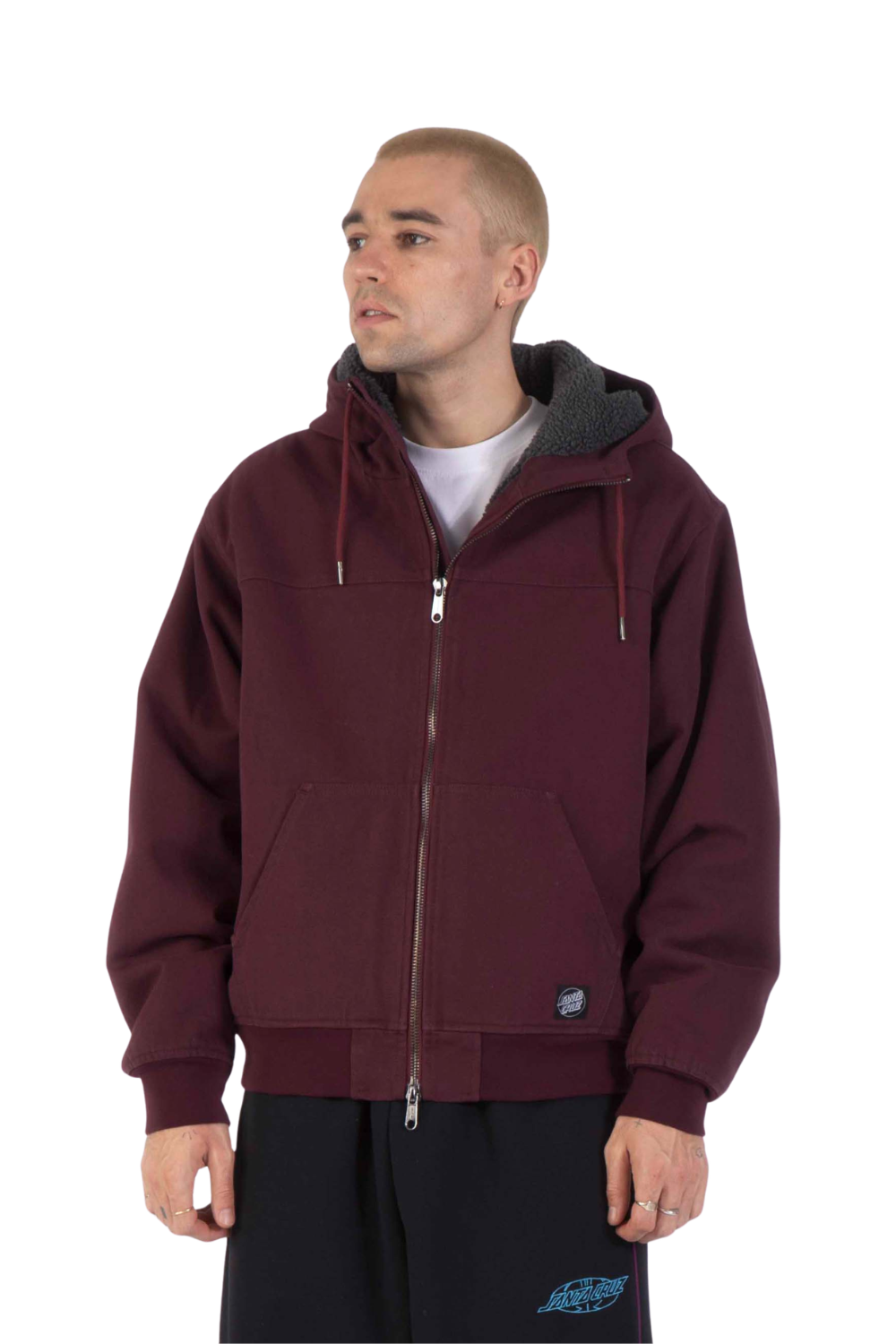 Man wearing a bomber jacket in dark plum colour with a Santa Cruz label on the bottom left, shown on a white background.