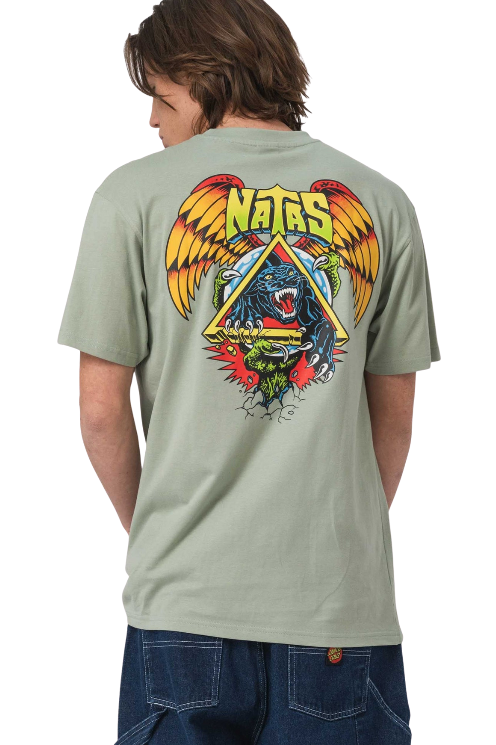 Person wearing a light green t-shirt with a colorful graphic design on the back, standing against a white background.