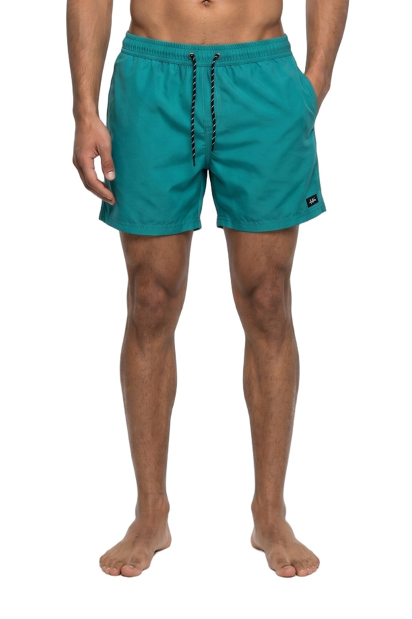 Teal swim shorts worn by a person on a white background