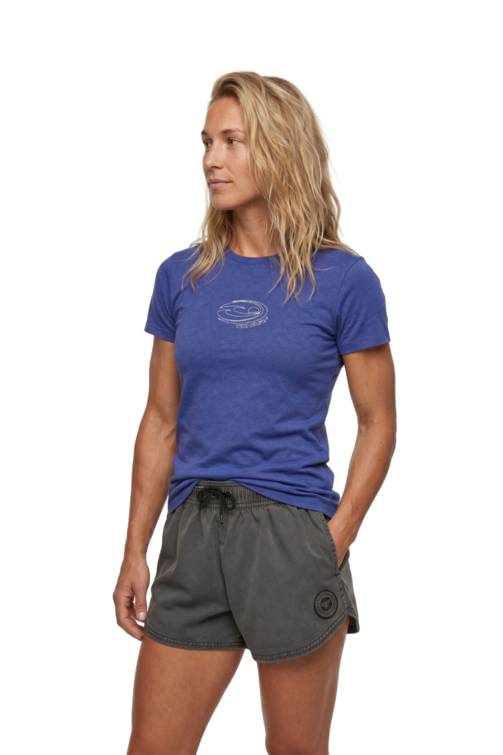 Woman wearing a blue t-shirt with a chest logo on a white background
