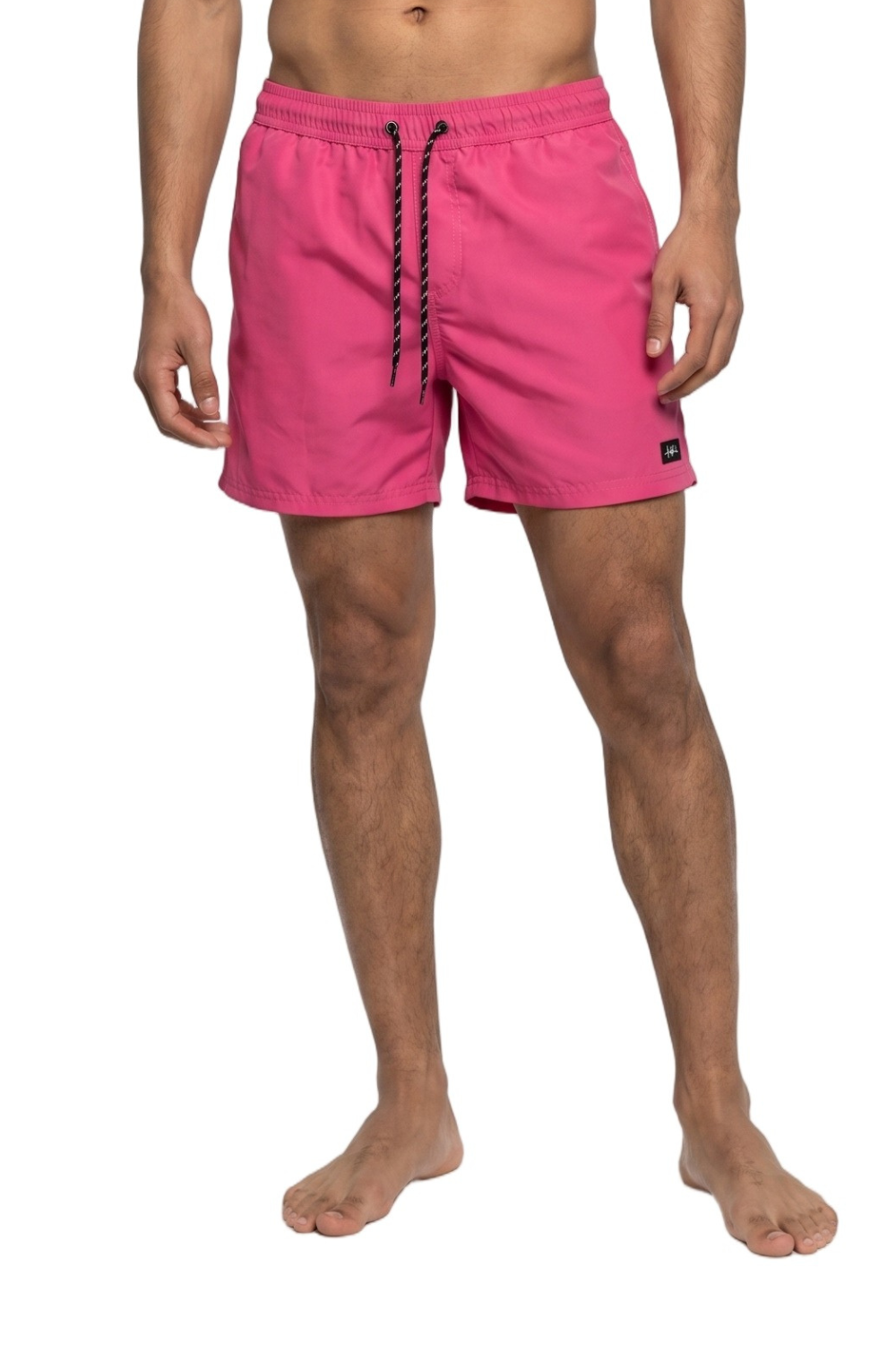 Person wearing bright pink swim shorts with a drawstring on a white background