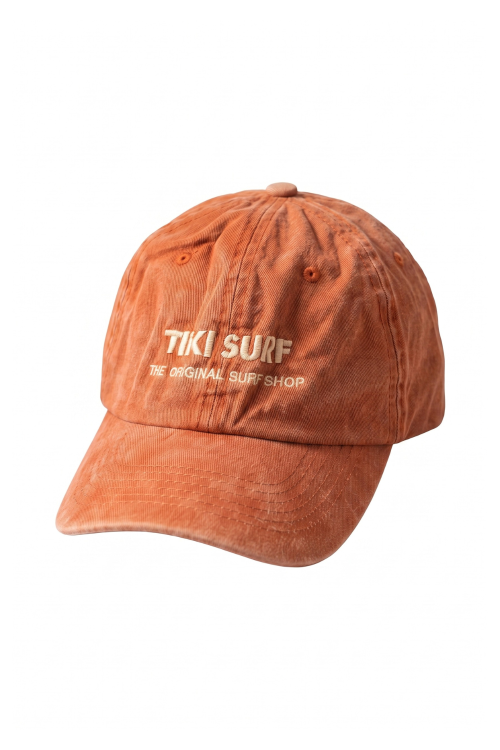 A washed orange-brown baseball cap with 'TIKI SURF THE ORIGINAL SURF SHOP' embroidered in cream on the front, shown against a plain white background.