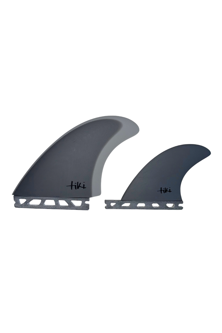 Two grey surfboard fins on a white background