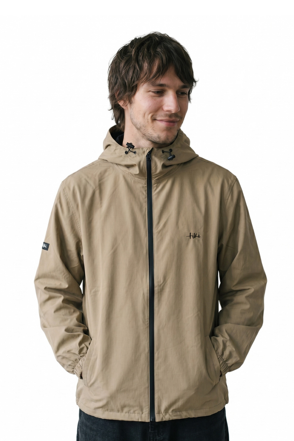 Man wearing a beige jacket with a hood on a white background