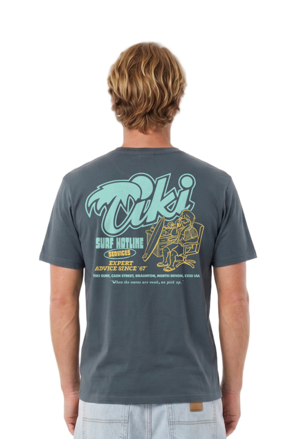 Person wearing a dark gray t-shirt with a Tiki brand logo on the back, standing against a white background