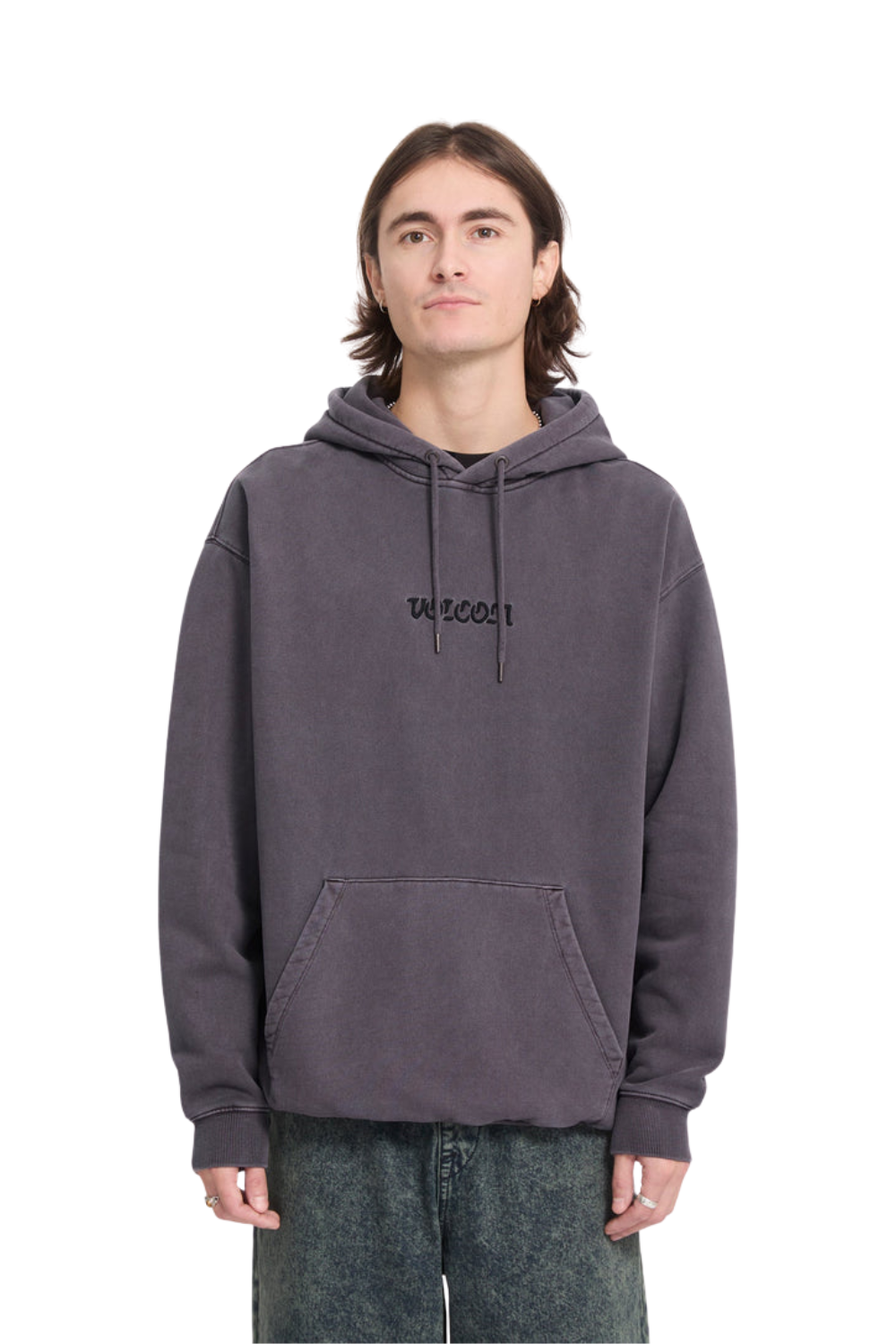 A man wearing a dark brown hoodie with an embroidered Volcom logo on the chest.