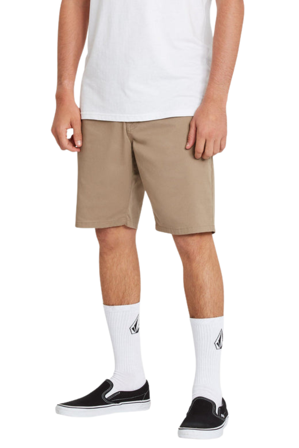 Person wearing beige shorts, white socks with a logo, and black sneakers on a white background