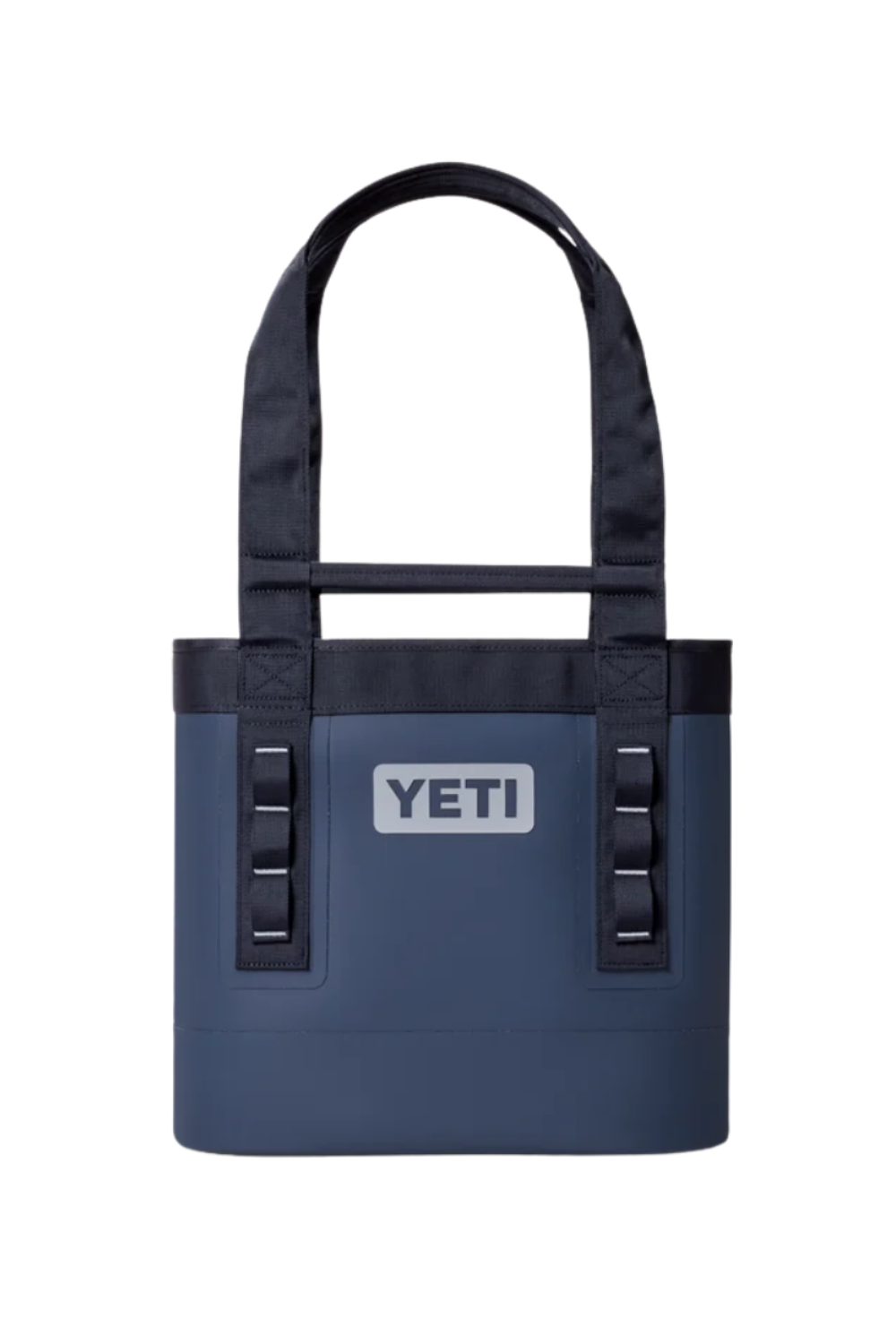 A YETI insulated tote bag in navy blue with black handles and trim, featuring the white YETI logo on the front, set against a plain white background.
