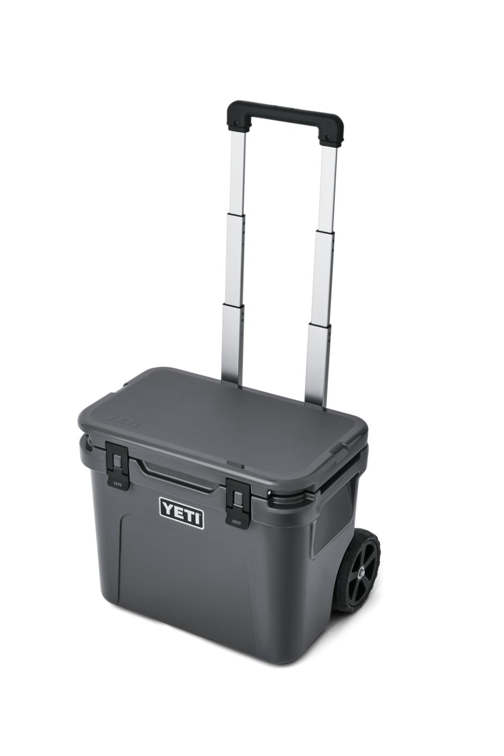 A YETI rolling cooler in dark gray with a black lid, featuring a silver telescoping handle and a black wheel, shown on a white background.