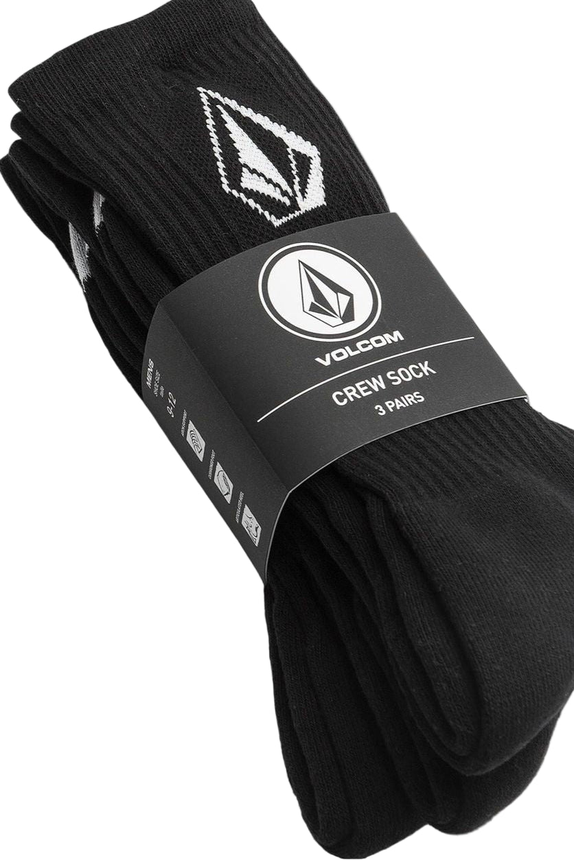 Three pairs of black crew socks with a white Volcom logo on the ankle area, packaged together.